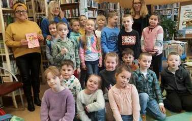 Zdjęcie grupowe dzieci z wychowawcą klasy i dwiema bibliotekarkami.