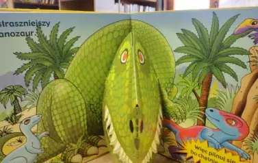 Rozłożona książeczka z dinozaurem w formacie 3D