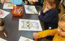 Przy stole siedzą dzieci i kolorują zwierzątka.