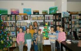 Grupowe zdjęcie dzieci z Panią nauczycielką przy choince.
